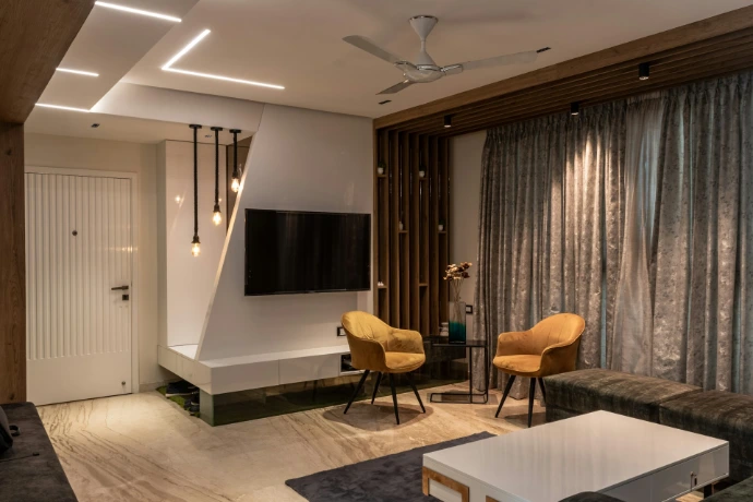 a living room with a tv and chairs